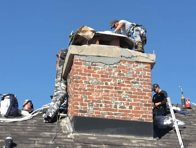Sagamore Hills Chimney Sweep installing a custom chimney crown in Sagamore Hills, OH