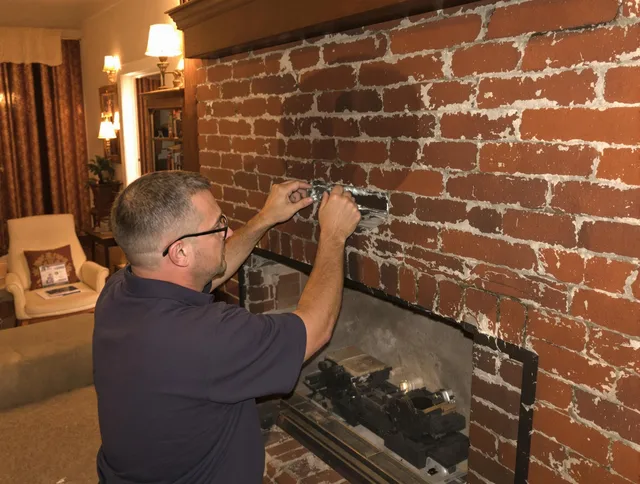 Sagamore Hills Chimney Sweep expert fixing a fireplace in Sagamore Hills, OH